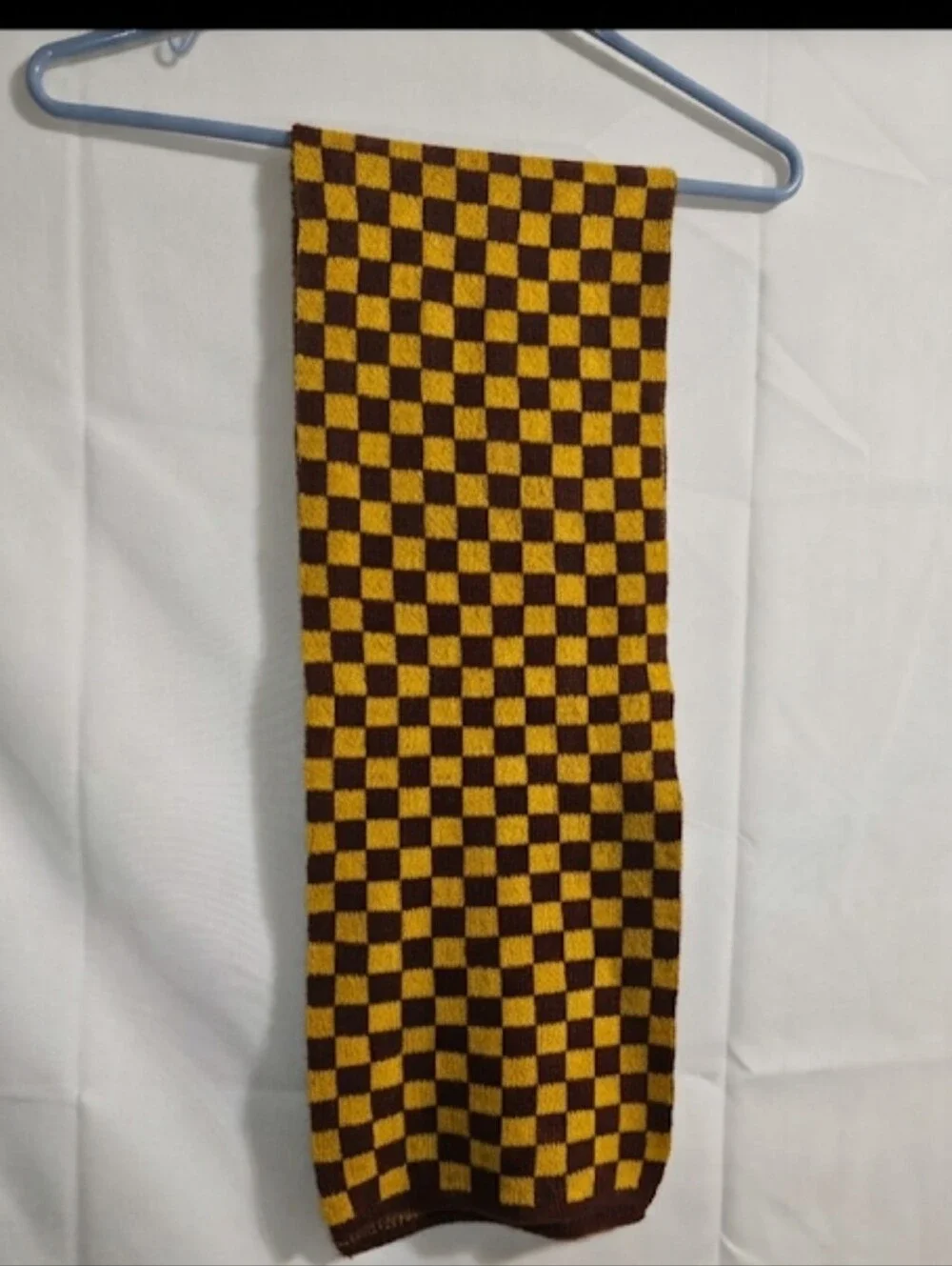 soft knit scarf  brown and mustard yellow checkerboard pattern.